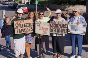 group of sisters holding signs